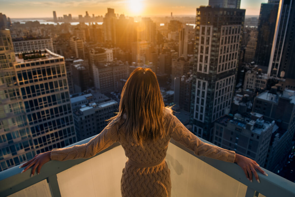 Luxury real estate agent woman looking at the sunset