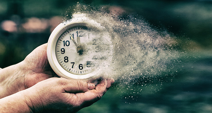 Hands holding a clock