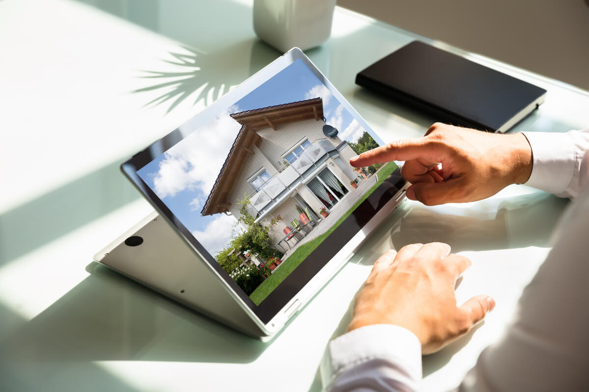 Person browses home listings on a tablet