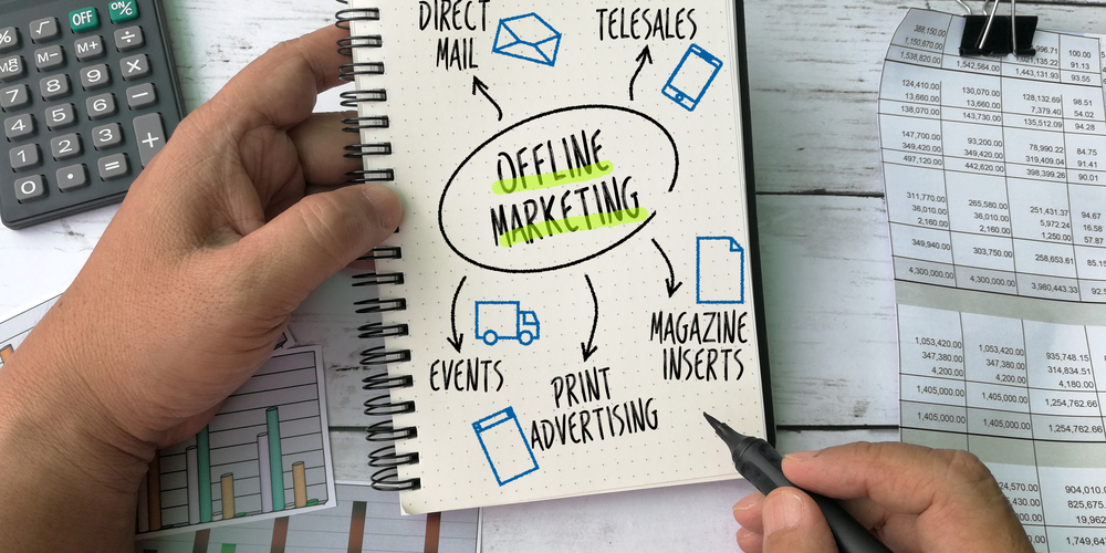 Notebook with the writing: Offline Marketing