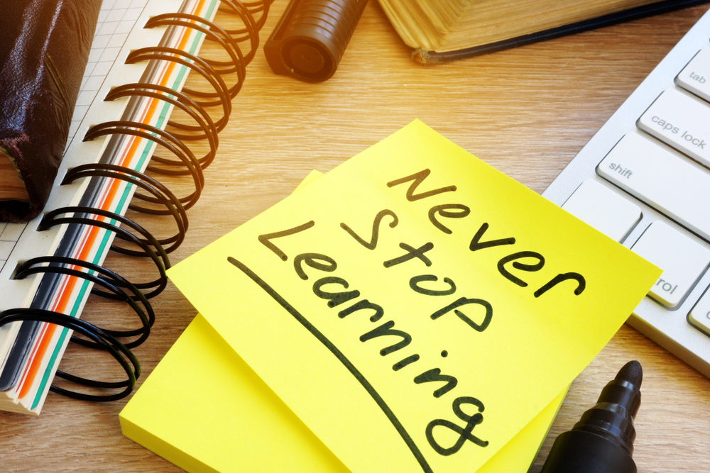 ongoing real estate education, sticky notes beside a computer